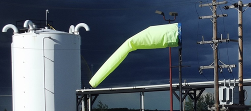 Caution yellow windsock on dangerous work site.