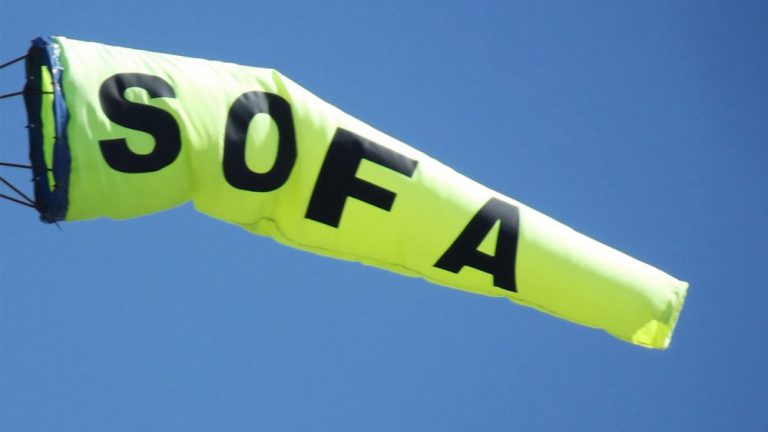 Yellow windsock with S O F A written on the side.