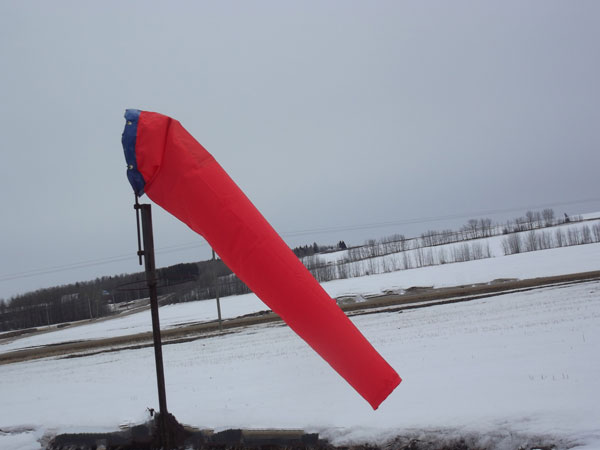 Red windsock on snowy background